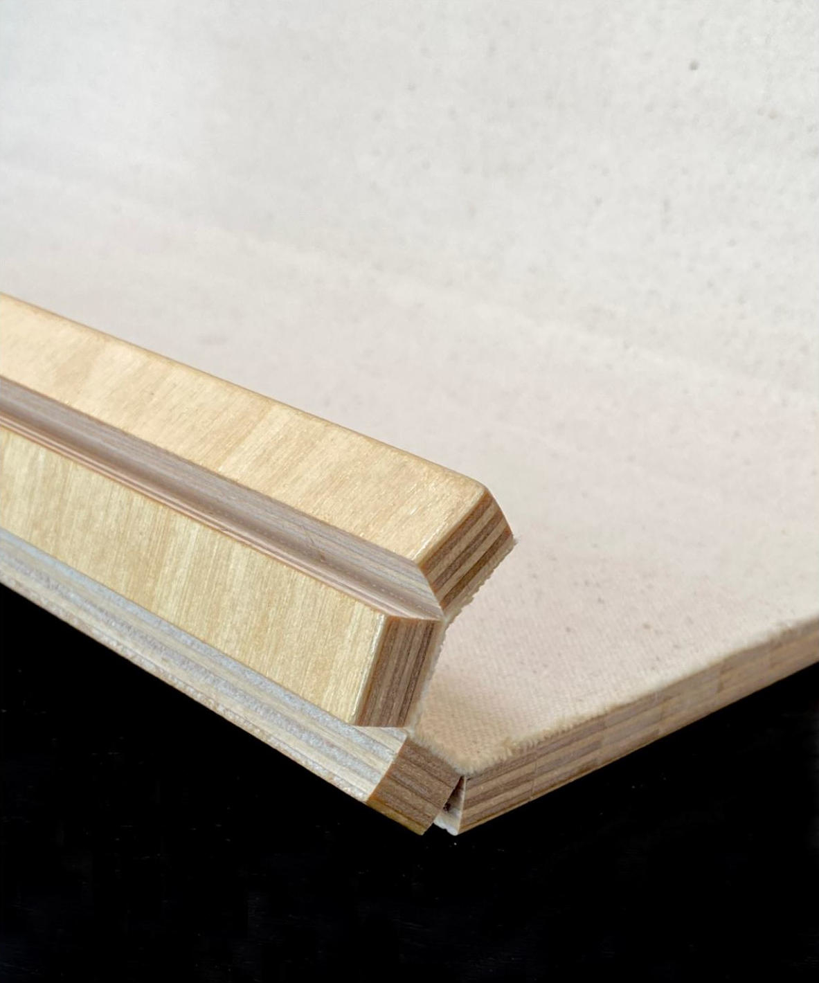 The lids are made from ½” wide slats glued to a canvas backing, similar to a tambour door. This construction allows the lids to be flexible and conform to the curved profile of the toolbox.